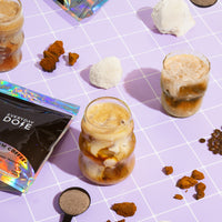 Mushroom Coffee servings with ice cream and coffee beans on purple gridded surface, showing Black Friday product
