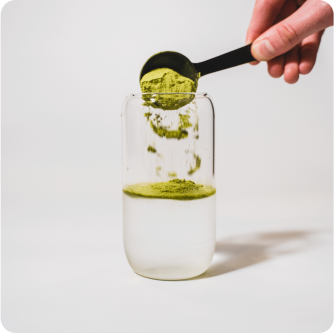 everyday dose matcha blend being poured into cup