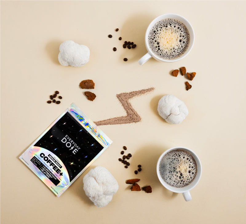 Two cups of coffee with a package labeled 'Everyday Dose Coffee' on a beige background.