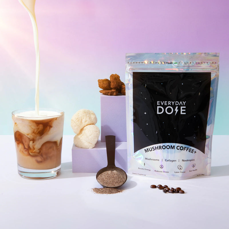 Everyday Dose Mushroom Coffee+ starter kit with creamy pour, coffee beans, and powder on pastel background