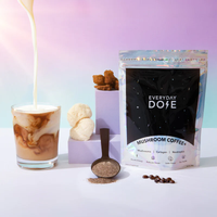 Everyday Dose Coffee+ holographic bag with powdered coffee and fresh mushrooms beside glass of creamy coffee in gallery position 1