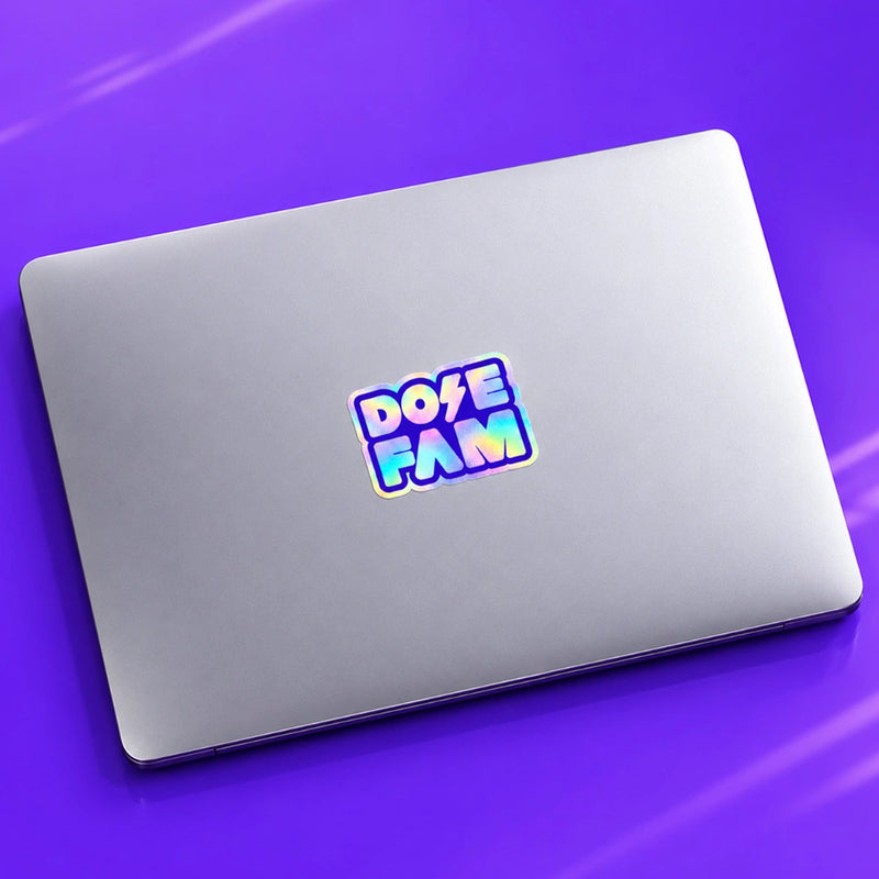 Silver laptop with a colorful Dote Fam sticker resting on a vivid purple surface