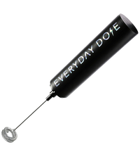 Angled view of USB rechargeable frother showcasing gunmetal finish, twisted whisk, and Everyday Dose logo on white background