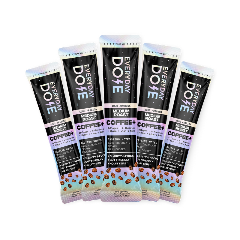Five medium roast coffee stick packs with dark packaging and colorful accents arranged in a fan shape with coffee bean illustrations at the bottom