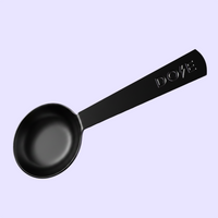 Black ladle with a long handle marked DOVE against a pale lavender background
