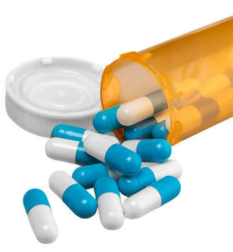 Orange prescription bottle tipped over with blue and white capsules spilling out on white background